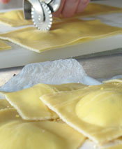 Place Ravioli on Corn Meal Covered Parchment Paper